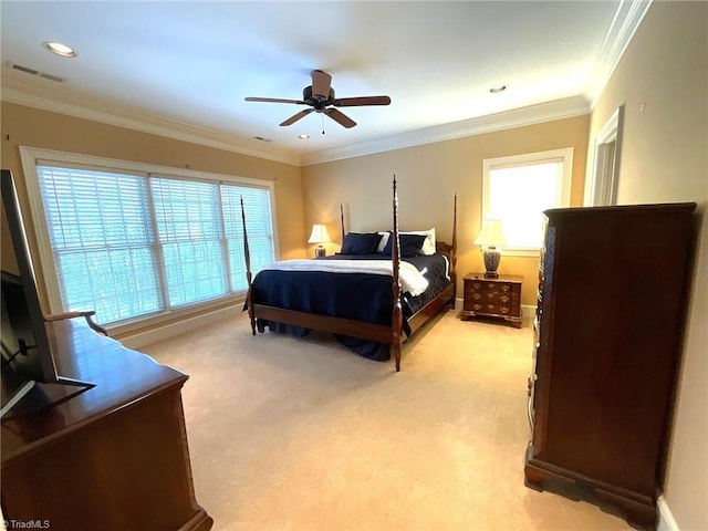 bedroom with multiple windows, ceiling fan, and light colored carpet