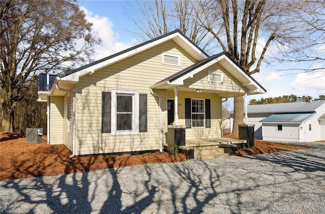 bungalow-style home with central AC and covered porch