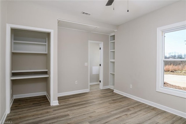 unfurnished bedroom featuring wood-type flooring and ceiling fan