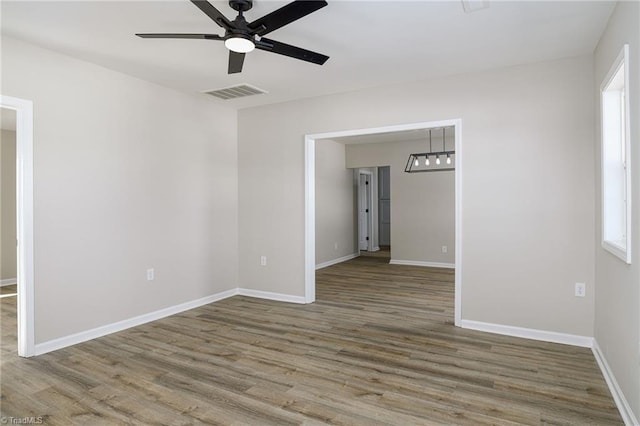 unfurnished room featuring hardwood / wood-style floors and ceiling fan