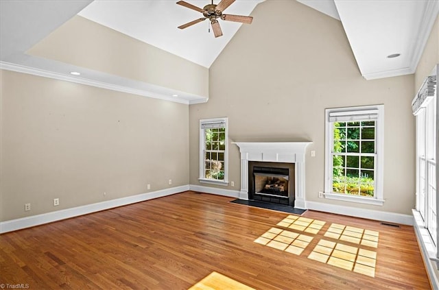 920 James Doak Pkwy, Greensboro, NC 27455 - unfurnished living room with a ceiling fan, wood finished floors, high vaulted ceiling, a fireplace with flush hearth, and ornamental molding