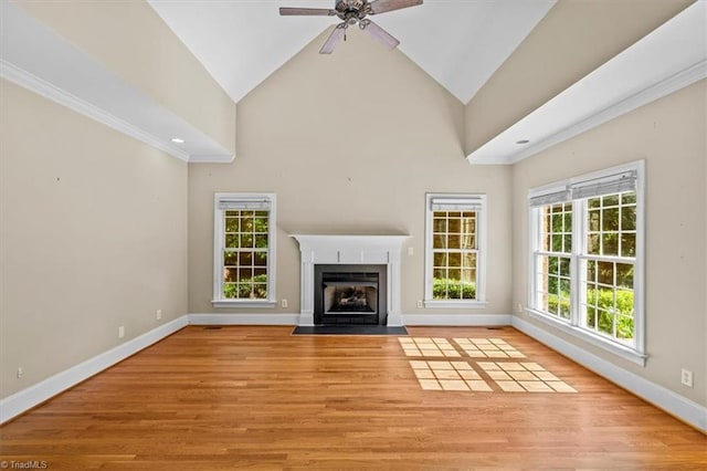 920 James Doak Pkwy, Greensboro, NC 27455 - unfurnished living room featuring a fireplace with flush hearth, ceiling fan, light wood-style floors, crown molding, and high vaulted ceiling