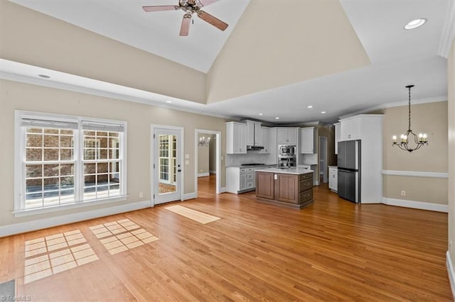 920 James Doak Pkwy, Greensboro, NC 27455 - kitchen with appliances with stainless steel finishes, open floor plan, a chandelier, ceiling fan, and light wood-type flooring