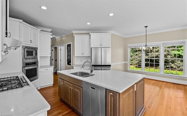 920 James Doak Pkwy, Greensboro, NC 27455 - kitchen featuring stainless steel appliances, crown molding, white cabinetry, wood finished floors, and tasteful backsplash