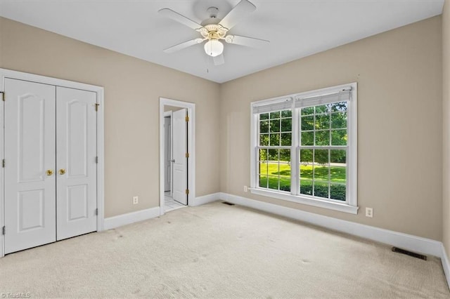 920 James Doak Pkwy, Greensboro, NC 27455 - unfurnished bedroom featuring carpet floors, ceiling fan, a closet, and connected bathroom