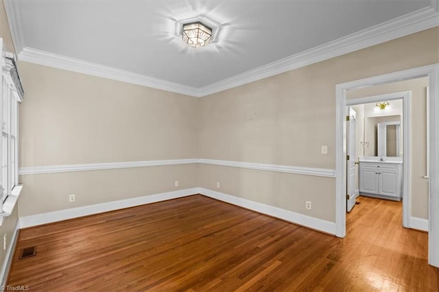 920 James Doak Pkwy, Greensboro, NC 27455 - empty room featuring wood finished floors and ornamental molding