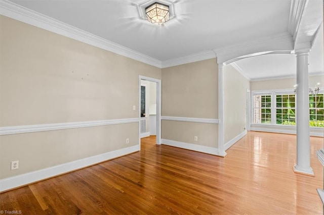 920 James Doak Pkwy, Greensboro, NC 27455 - unfurnished room featuring decorative columns, crown molding, wood finished floors, and arched walkways