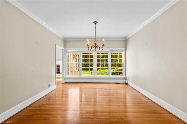 920 James Doak Pkwy, Greensboro, NC 27455 - unfurnished dining area featuring a chandelier, wood finished floors, and ornamental molding