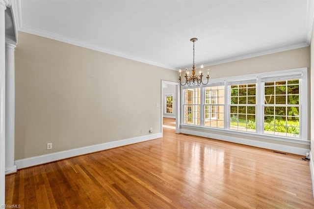 920 James Doak Pkwy, Greensboro, NC 27455 - unfurnished dining area with a chandelier, ornate columns, wood finished floors, and crown molding