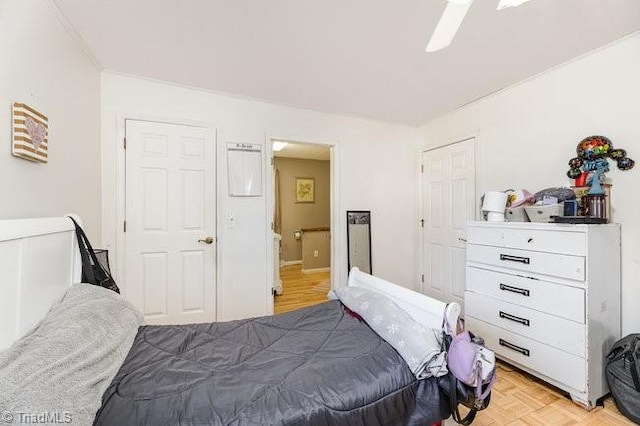 bedroom with ceiling fan and light parquet floors