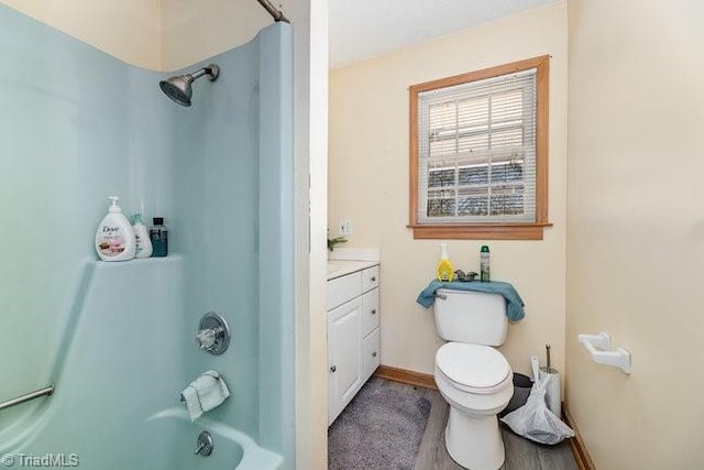 full bathroom featuring hardwood / wood-style floors, vanity, shower / bath combination, and toilet