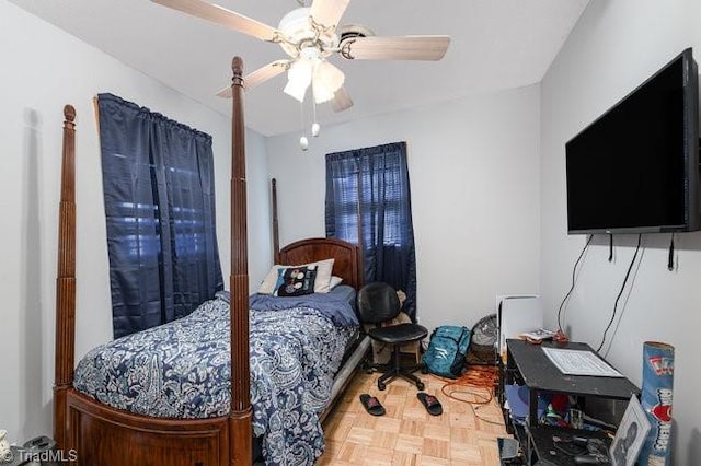 bedroom featuring parquet flooring and ceiling fan