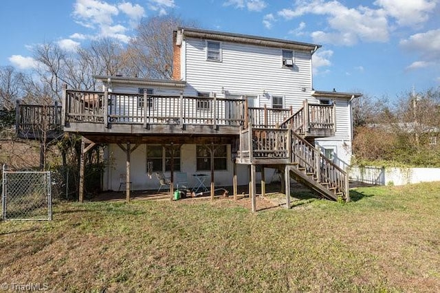 rear view of house featuring a deck and a yard