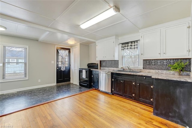 kitchen featuring dishwasher, light wood-style flooring, white cabinetry, black / electric stove, and a sink