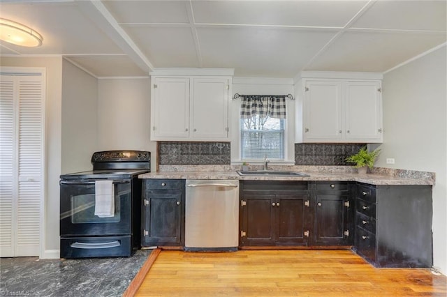 kitchen with stainless steel dishwasher, black electric range oven, white cabinetry, and a sink