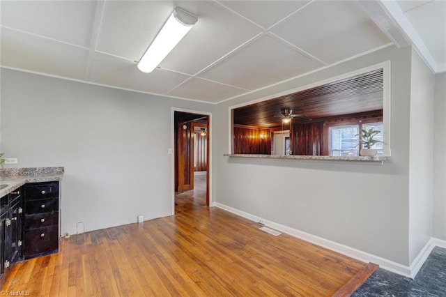 interior space featuring baseboards and hardwood / wood-style floors