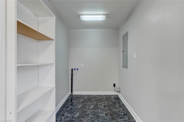 washroom featuring laundry area, electric panel, and baseboards