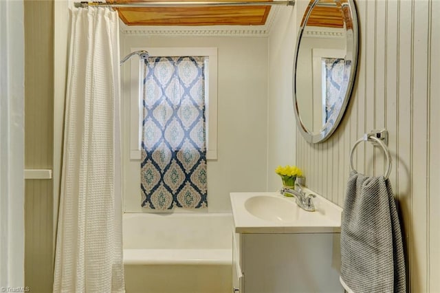 bathroom featuring shower / bath combo and vanity