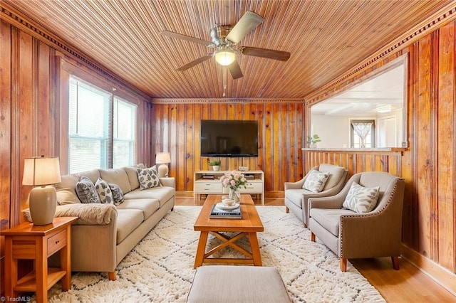 living room with a ceiling fan, wooden walls, wood finished floors, and wooden ceiling