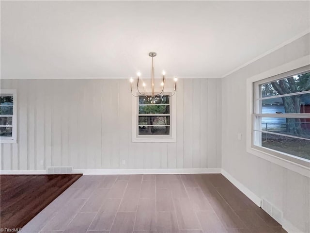 5622 Ruth Ave, Winston-Salem, NC 27105 - unfurnished dining area featuring an inviting chandelier and wood-type flooring