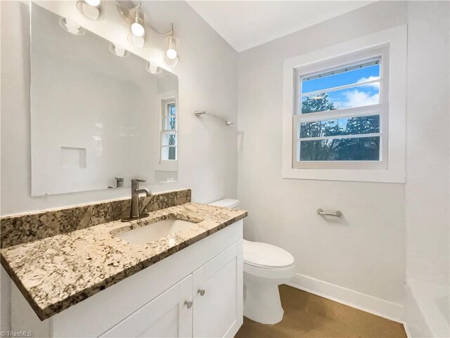 5622 Ruth Ave, Winston-Salem, NC 27105 - bathroom featuring vanity, toilet, and a wealth of natural light