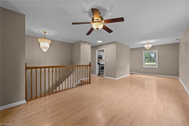 131 Springdale Dr, Stoneville, NC 27048 - empty room featuring baseboards, ceiling fan with notable chandelier, and wood finished floors