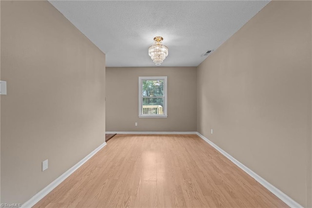 131 Springdale Dr, Stoneville, NC 27048 - spare room featuring baseboards, light wood-style flooring, and visible vents