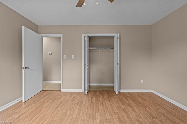 131 Springdale Dr, Stoneville, NC 27048 - unfurnished bedroom featuring baseboards, a ceiling fan, light wood-style flooring, and a closet