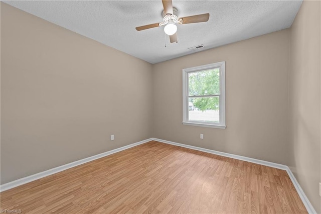 131 Springdale Dr, Stoneville, NC 27048 - unfurnished room with a textured ceiling, baseboards, visible vents, and light wood-type flooring