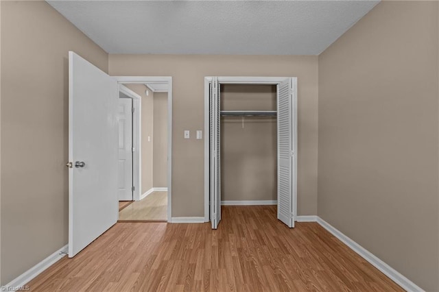 131 Springdale Dr, Stoneville, NC 27048 - unfurnished bedroom featuring a closet, baseboards, and light wood-type flooring