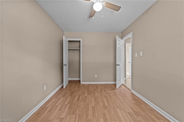 131 Springdale Dr, Stoneville, NC 27048 - unfurnished bedroom featuring light wood-style floors, baseboards, a ceiling fan, and a closet