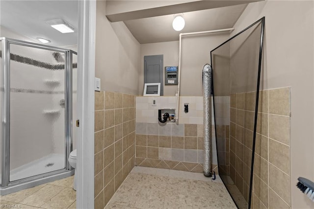 131 Springdale Dr, Stoneville, NC 27048 - full bath featuring tile patterned floors, a shower stall, toilet, and tile walls