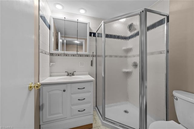 131 Springdale Dr, Stoneville, NC 27048 - bathroom featuring vanity, a shower stall, toilet, and tile walls