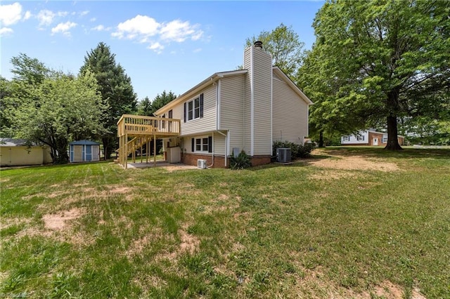 131 Springdale Dr, Stoneville, NC 27048 - rear view of house featuring an outdoor structure, a wooden deck, a chimney, a storage shed, and a yard