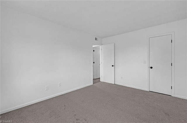 unfurnished bedroom featuring visible vents, baseboards, and carpet floors