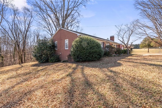 view of side of property with a yard