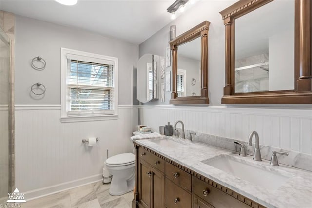 bathroom with vanity, toilet, and a shower with shower door