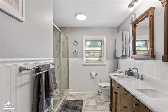 bathroom featuring vanity, toilet, and an enclosed shower