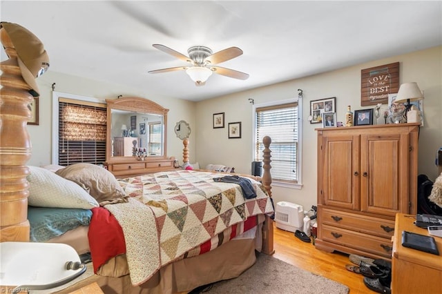 bedroom with ceiling fan and light wood-type flooring