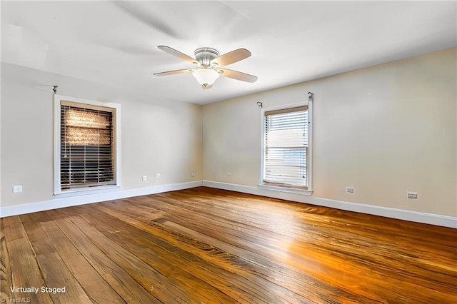 empty room featuring hardwood / wood-style floors and ceiling fan