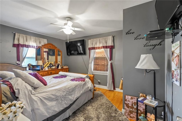 bedroom with hardwood / wood-style floors and ceiling fan