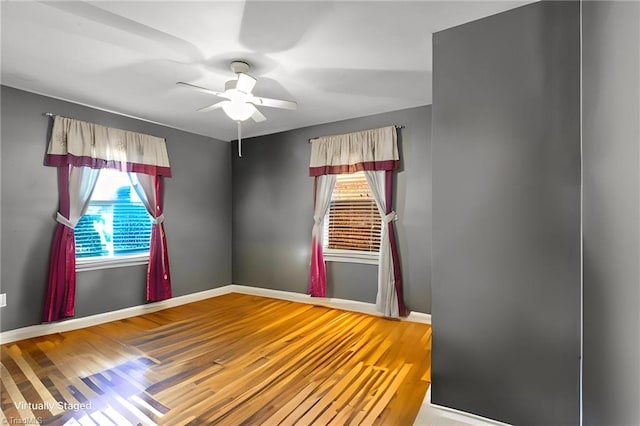 unfurnished room with wood-type flooring and ceiling fan