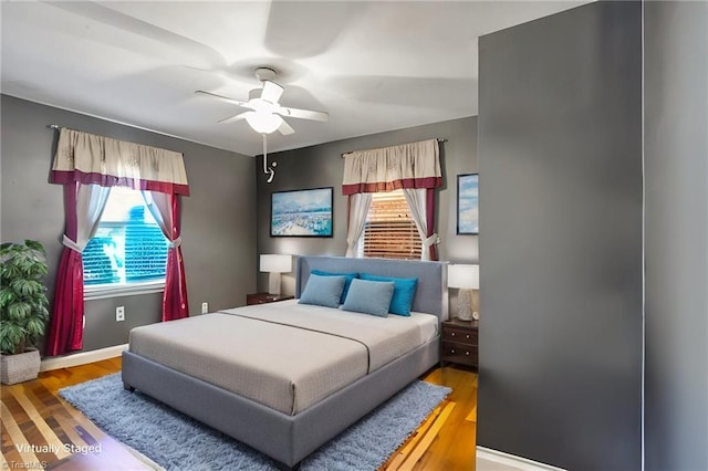 bedroom with hardwood / wood-style flooring and ceiling fan