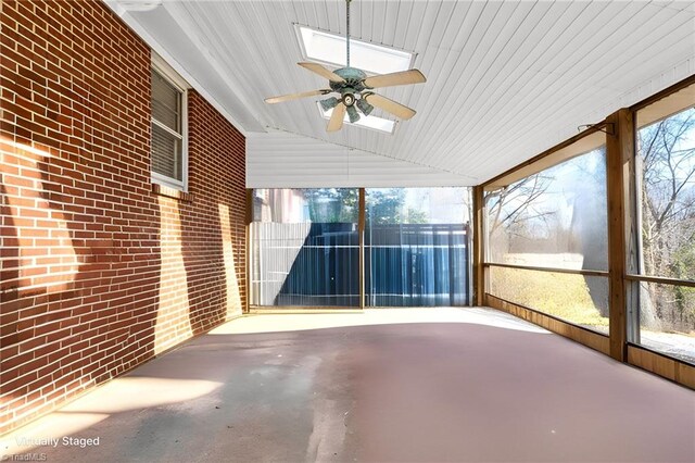 unfurnished sunroom featuring vaulted ceiling and ceiling fan