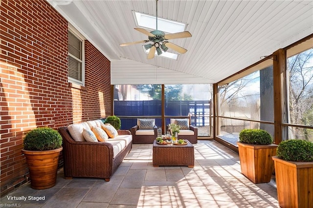 sunroom / solarium featuring ceiling fan and vaulted ceiling