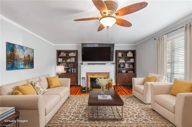 living room with hardwood / wood-style floors, crown molding, and ceiling fan