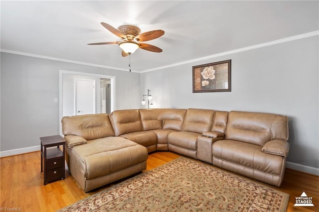 living room with hardwood / wood-style flooring, ceiling fan, and ornamental molding