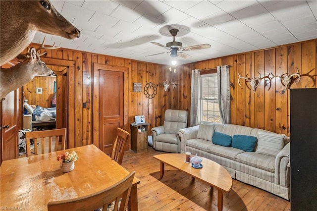 living room with ceiling fan and light wood-type flooring