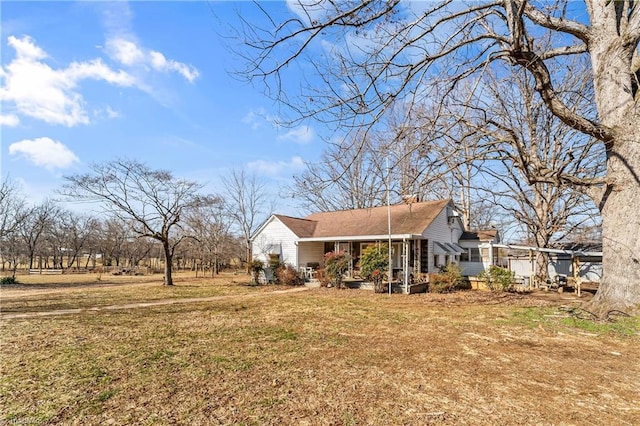 view of home's exterior with a porch and a yard