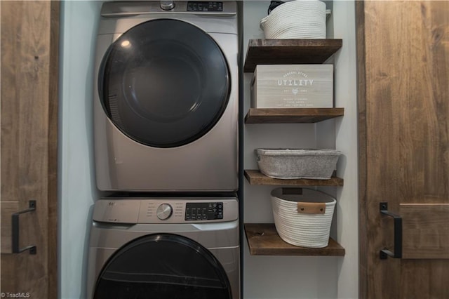 washroom featuring stacked washer / dryer